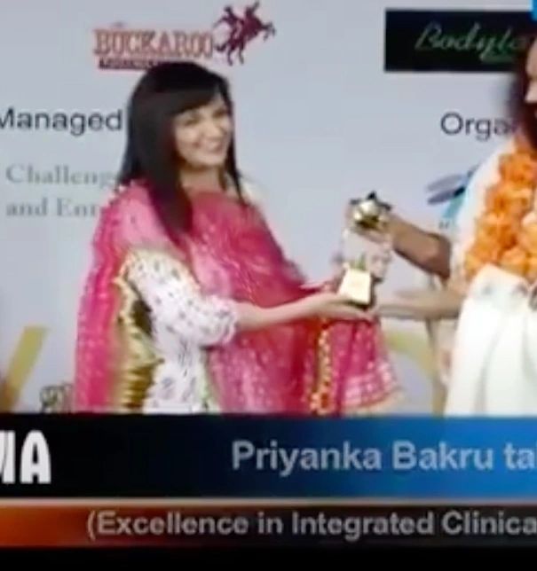 Priyanka Bakhru receiving Excellence in Integrated Clinical award